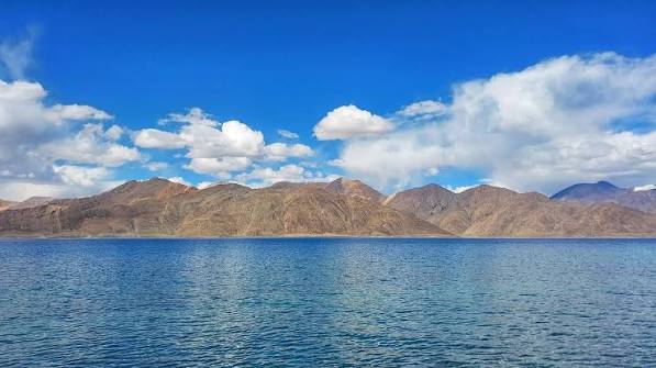Breathtaking sapphire blue waters of Pangong Lake under vibrant summer skies in August