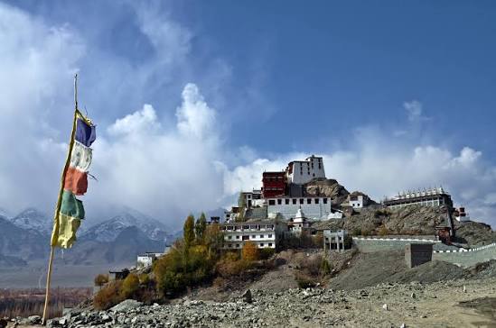 Hilltop Buddhist monastery in Ladakh Indus Valley with prayer flags in October